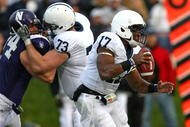 EVANSTON, IL - OCTOBER 31: Daryll Clark #17 of the Penn State Nittany Lions runs with the ball as teammate Dennis Landolt #73 blocks Vince Browne #94 of the Northwestern Wildcats at Ryan Field on October 31, 2009 in Evanston, Illinois. Penn State defeated Northwestern 34-13. (Photo by Jonathan Daniel/Getty Images)