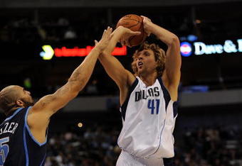 DALLAS - NOVEMBER 03:  Forward Dirk Nowitzki #41 of the Dallas Mavericks takes a shot against Carlos Boozer #5 of the Utah Jazz on November 3, 2009 at American Airlines Center in Dallas, Texas.  NOTE TO USER: User expressly acknowledges and agrees that, by downloading and/or using this Photograph, user is consenting to the terms and conditions of the Getty Images License Agreement.  (Photo by Ronald Martinez/Getty Images)