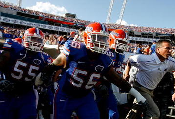 JACKSONVILLE, FL - OCTOBER 31:  Head coach Urban Meyer (R) of the Florida Gators leads his team onto the field to face the Georgia Bulldogs at Jacksonville Municipal Stadium on October 31, 2009 in Jacksonville, Florida.  (Photo by Kevin C. Cox/Getty Images)