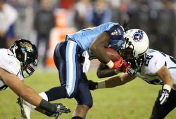 NASHVILLE, TN - NOVEMBER 01:  Chris Johnson #28 of the Tennessee Titans hits Brian Russell #26 of the Jacksonville Jaguars during their game at LP Field on November 1, 2009 in Nashville, Tennessee.  (Photo by Streeter Lecka/Getty Images)
