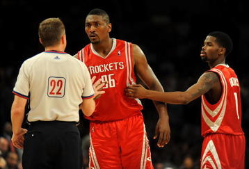 LOS ANGELES, CA - MAY 06:  Ron Artest #96 of the Houston Rockets talks with referee Bill Spooner as Artest is held back by teammate Aaron Brooks #0 before Artest was ejected in the fourth quarter against the Los Angeles Lakers in Game Two of the Western Conference Semifinals during the 2009 NBA Playoffs at Staples Center on May 6, 2009 in Los Angeles, California. NOTE TO USER: User expressly acknowledges and agrees that, by downloading and or using this photograph, User is consenting to the terms and conditions of the Getty Images License Agreement.  (Photo by Harry How/Getty Images)