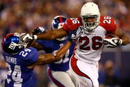 EAST RUTHERFORD, NJ - OCTOBER 25:  Beanie Wells #26 of the Arizona Cardinals fends off Terrell Thomas #24 of the New York Giants on October 25, 2009 at Giants Stadium in East Rutherford, New Jersey.  (Photo by Chris McGrath/Getty Images)