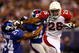 EAST RUTHERFORD, NJ - OCTOBER 25:  Beanie Wells #26 of the Arizona Cardinals fends off Terrell Thomas #24 of the New York Giants on October 25, 2009 at Giants Stadium in East Rutherford, New Jersey.  (Photo by Chris McGrath/Getty Images)