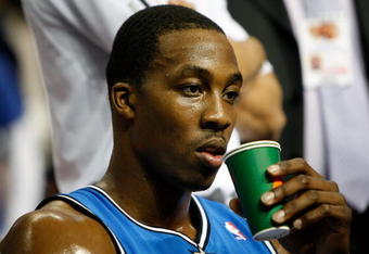 AUBURN HILLS, MI - MAY 13:  Dwight Howard #12 of the Orlando Magic takes a drink on the bench against the Detroit Pistons in Game Five of the Eastern Conference Semifinals during the 2008 NBA Playoffs at the Palace of Auburn Hills in Auburn Hills, Michigan.  NOTE TO USER: User expressly acknowledges and agrees that, by downloading and or using this photograph, User is consenting to the terms and conditions of the Getty Images License Agreement.  (Photo by Gregory Shamus/Getty Images)