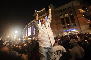 NEW YORK - NOVEMBER 04:  Fans celebrate outside Yankee Stadium following the New York Yankees victory over the Philadelphia Phillies in Game Six of the 2009 MLB World Series on November 4, 2009 in the Bronx borough of New York City.The Yankees defeated the Phillies 7-3 to win their 27th championship.  (Photo by Mario Tama/Getty Images)