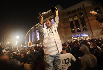 NEW YORK - NOVEMBER 04:  Fans celebrate outside Yankee Stadium following the New York Yankees victory over the Philadelphia Phillies in Game Six of the 2009 MLB World Series on November 4, 2009 in the Bronx borough of New York City.The Yankees defeated the Phillies 7-3 to win their 27th championship.  (Photo by Mario Tama/Getty Images)