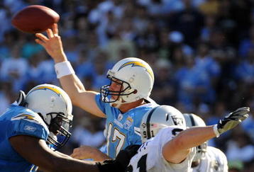 SAN DIEGO - NOVEMBER 01:  Philip Rivers #17 of the San Diego Chargers thorws as he is rushed by Trevor Scott #91 of the Oakland Raiders during the second quarter at Qualcomm Stadium on November 1, 2009 in San Diego California.  (Photo by Harry How/Getty Images)