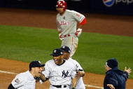 NEW YORK - NOVEMBER 04: Mark Teixeira (L) and Mariano Rivera (C) of the New York Yankees celebrate their 7-3 win as Shane Victorino #8 of the Philadelphia Phillies walks off the field dejected in Game Six of the 2009 MLB World Series at Yankee Stadium on November 4, 2009 in the Bronx borough of New York City. (Photo by Chris McGrath/Getty Images)