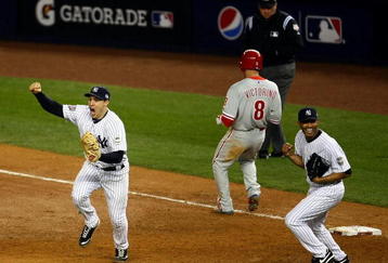 NEW YORK - NOVEMBER 04:  Mark Teixeira #25 (L) and Mariano Rivera #42 (R) of the New York Yankees celebrate after against Shane Victorino #8 (C) of the Philadelphia Phillies grounded out for the final out of the Yankees 7-3 win in Game Six of the 2009 MLB World Series at Yankee Stadium on November 4, 2009 in the Bronx borough of New York City.  (Photo by Chris McGrath/Getty Images)