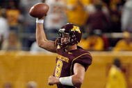 MINNEAPOLIS - NOVEMBER 01: Adam Weber #8 of the Minnesota Golden Gophers fakes a pass down field as he scrambles out of the pocket against the Northwestern Wildcats during the third quarter at the Hubert H.Humphrey Metrodome on November 1, 2008 in Minneapolis, Minnesota. (Photo by Harry How/Getty Images)