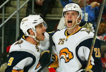 NEWARK, NJ - DECEMBER 13:  Thomas Vanek #26 of the Buffalo Sabres celebrates his third period goal and 10,000 in team history with teammate  Derek Roy #9 against the New Jersey Devils  at the Prudential Center on December 13, 2008 in Newark, New Jersey. Sabres win 4-2  (Photo by Mike Stobe/Getty Images)