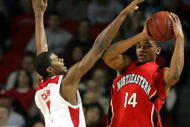LOUISVILLE, KY - DECEMBER 27:  Earl Clark #5 of the Louisville Cardinals defends Bennet Davis #14 of the Northeastern Huskies on December 27, 2006 at Freedom Hall in Louisville, Kentucky.  (Photo by Andy Lyons/Getty Images)