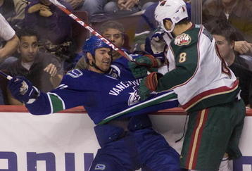 VANCOUVER, CANADA - OCTOBER 17: Darcy Hordichuk #24 of the Vancouver Canucks reacts after getting hit by Brent Burns #8 of the Minnesota Wild during the third period of NHL action on October 17, 2009 at General Motors Place in Vancouver, British Columbia, Canada.  (Photo by Rich Lam/Getty Images)