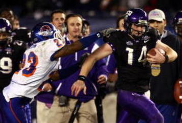 SAN DIEGO, CA - DECEMBER 23:  Quarterback Andy Dalton #14 of  TCU runs with the ball against the tackle of Safety Jeron Johnson #23 of Boise State during the San Diego County Credit Union Poinsettia Bowl at Qualcomm Stadium on December 23, 2008 in San Diego, California. (Photo by Donald Miralle/Getty Images)