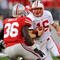 COLUMBUS, OH - OCTOBER 10:  Quarterback Scott Tolzien #16 of the Wisconsin Badgers looks for running room as Brian Rolle #36 of the Ohio State Buckeyes closes in for the tackle at Ohio Stadium on October 10, 2009 in Columbus, Ohio.  (Photo by Jamie Sabau/Getty Images)