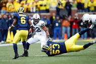 ANN ARBOR, MI - OCTOBER 24:  Evan Royster #22 of the Penn State Nittany Lions carries the ball against Donovan Warren #6 and Ryan Van Bergen #53 of the Michigan Wolverines on October 24, 2009 at Michigan Stadium in Ann Arbor, Michigan. (Photo by  Gregory Shamus/Getty Images)