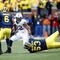 ANN ARBOR, MI - OCTOBER 24:  Evan Royster #22 of the Penn State Nittany Lions carries the ball against Donovan Warren #6 and Ryan Van Bergen #53 of the Michigan Wolverines on October 24, 2009 at Michigan Stadium in Ann Arbor, Michigan. (Photo by  Gregory Shamus/Getty Images)