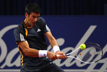 BASEL, SWITZERLAND - NOVEMBER 05:  Novak Djokovic of Serbia plays a backhand in his match against Jan Hernych of Czech Republic during Day Four of the Davidoff Swiss Indoors Tennis at St Jakobshalle on November 5, 2009 in Basel, Switzerland.  (Photo by Julian Finney/Getty Images)