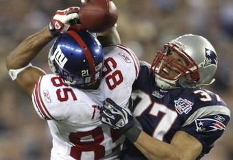 GLENDALE, AZ - FEBRUARY 03:  David Tyree #85 of the New York Giants catches a 32-yard pass from Eli Manning #10 as Rodney Harrison #37 of the New England Patriots attempts to knock it out in the fourth quarter of Super Bowl XLII on February 3, 2008 at the University of Phoenix Stadium in Glendale, Arizona.  (Photo by Andy Lyons/Getty Images)