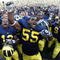ANN ARBOR, MI - SEPTEMBER 05:  Brandon Graham #55 of the Michigan Wolverines leads his teammates in singing the schools fight song after beating the Western Michigan Broncos 31-7 on September 5, 2009 at Michigan Stadium in Ann Arbor, Michigan.  (Photo by Gregory Shamus/Getty Images)