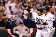 ST PETERSBURG, FL - OCTOBER 03: Akinori Iwamura #1 of the Tampa Bay Rays celebrates with Jason Bartlett #8 after Iwamura's two run home run in the fifth inning against the Chicago White Sox in Game 2 of the American Leaugue Divisional Series at Tropicana Field on October 3, 2008 in St. Petersburg, Florida. (Photo by Doug Benc/Getty Images)