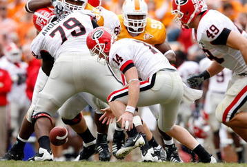 KNOXVILLE, TN - OCTOBER 10: Joe Cox #14 of the Georgia Bulldogs funmbles the ball during the SEC game against the Tennessee Volunteers at Neyland Stadium on October 10, 2009 in Knoxville, Tennessee. (Photo by Andy Lyons/Getty Images)