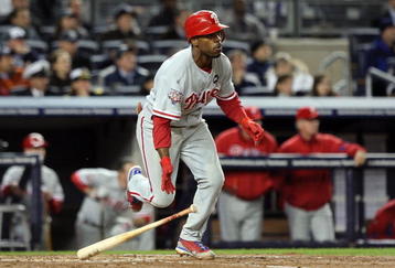 NEW YORK - NOVEMBER 04:  Jimmy Rollins #11 of the Philadelphia Phillies hits a sacrifice fly to drive in Carlos Ruiz #51 in the top of the third inning against the New York Yankees in Game Six of the 2009 MLB World Series at Yankee Stadium on November 4, 2009 in the Bronx borough of New York City.  (Photo by Jed Jacobsohn/Getty Images)