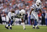 DENVER - OCTOBER 29: Linebacker Gary Brackett #58 and defensive end Dwight Freeney #93 of the Indianapolis Colts wait for the snap during the game against the Denver Broncos on October 29, 2006 at Invesco Field at Mile High in Denver, Colorado. The Colts won 34-31. (Photo by Brian Bahr/Getty Images)