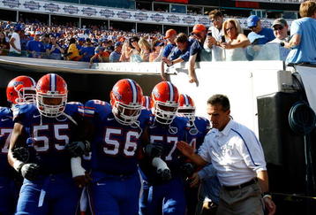JACKSONVILLE, FL - OCTOBER 31:  Head coach Urban Meyer (R) of the Florida Gators leads his team onto the field to face the Georgia Bulldogs at Jacksonville Municipal Stadium on October 31, 2009 in Jacksonville, Florida.  (Photo by Kevin C. Cox/Getty Images)