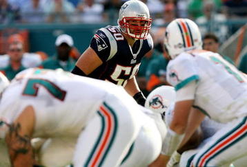 MIAMI - NOVEMBER 23:  Linebacker Mike Vrabel #50 of the New England Patriots looks in as quarterback Chad Pennington #10 of the Miami Dolphins prepares to take the snap at Dolphin Stadium on November 23, 2008 in Miami, Florida. The Patriots defeated the Dolphins 48-28.  (Photo by Doug Benc/Getty Images)