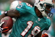 EAST RUTHERFORD, NJ - NOVEMBER 01:  Ted Ginn #19 of the Miami Dolphins returns a kick off during a game against the New York Jets at Giants Stadium on November 1, 2009 in East Rutherford, New Jersey.  (Photo by Chris Trotman/Getty Images)