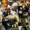 SOUTH BEND, IN - NOVEMBER 12: Quarterback Brian Hampton #3 of the Navy Midshipman is hit by linebackers Anthony Vernaglia #4, Joe Brockington #52 and Nick Borseti #56 of the Notre Dame Fighting Irish on November 12, 2005 at Notre Dame Stadium in South Bend, Indiana. Notre Dame defeated Navy 42-21. (Photo by Jonathan Daniel/Getty Images)