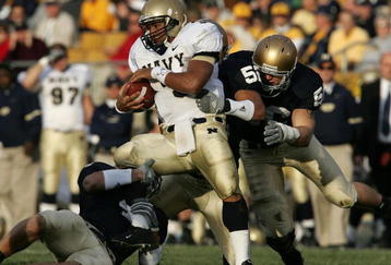 SOUTH BEND, IN - NOVEMBER 12: Quarterback Brian Hampton #3 of the Navy Midshipman is hit by linebackers Anthony Vernaglia #4, Joe Brockington #52 and Nick Borseti #56 of the Notre Dame Fighting Irish on November 12, 2005 at Notre Dame Stadium in South Bend, Indiana. Notre Dame defeated Navy 42-21. (Photo by Jonathan Daniel/Getty Images)