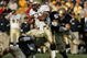 SOUTH BEND, IN - NOVEMBER 12: Quarterback Brian Hampton #3 of the Navy Midshipman is hit by linebackers Anthony Vernaglia #4, Joe Brockington #52 and Nick Borseti #56 of the Notre Dame Fighting Irish on November 12, 2005 at Notre Dame Stadium in South Bend, Indiana. Notre Dame defeated Navy 42-21. (Photo by Jonathan Daniel/Getty Images)