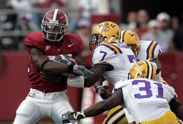TUSCALOOSA, AL - NOVEMBER 12:  Kenneth Darby #34 of the University of Alabama is tackled by center Ali Highsmith #7 of Louisiana State University on November 12, 2005 at at Bryant-Denny Stadium in Tuscaloosa, Alabama.  (Photo by Chris Graythen/Getty Images) 