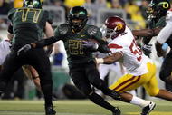 EUGENE, OR - OCTOBER 31: Running back LaMichael James #21 of the Oregon Ducks breaks through the line for a good gain in the third quarter of the game against the USC Trojans at Autzen Stadium on October 31, 2009 in Eugene, Oregon. James ran for 183 yards and a score as the Ducks upset the Trojans 47-20. (Photo by Steve Dykes/Getty Images)
