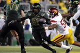 EUGENE, OR - OCTOBER 31: Running back LaMichael James #21 of the Oregon Ducks breaks through the line for a good gain in the third quarter of the game against the USC Trojans at Autzen Stadium on October 31, 2009 in Eugene, Oregon. James ran for 183 yards and a score as the Ducks upset the Trojans 47-20. (Photo by Steve Dykes/Getty Images)
