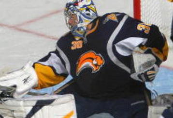 BUFFALO, NY - NOVEMBER 04: Ryan Miller #30 of the Buffalo Sabres makes a save as John Sim #16 of the New York Islanders skates in at HSBC Arena on November4, 2009 in Buffalo, New York.  (Photo by Rick Stewart/Getty Images)