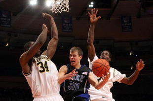 NEW YORK - NOVEMBER 21:  Jon Scheyer #30 of the Duke Blue Devils goes to the basket between DeShawn Sims #34 and Manny Harris #3 of the Michigan Wolverines on November 21, 2008 at Madison Square Garden in New York City.  (Photo by Nick Laham/Getty Images)