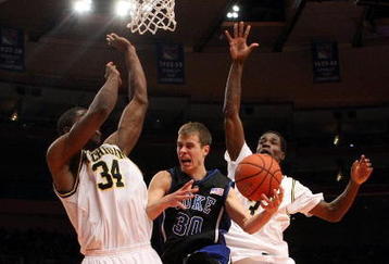 NEW YORK - NOVEMBER 21:  Jon Scheyer #30 of the Duke Blue Devils goes to the basket between DeShawn Sims #34 and Manny Harris #3 of the Michigan Wolverines on November 21, 2008 at Madison Square Garden in New York City.  (Photo by Nick Laham/Getty Images)