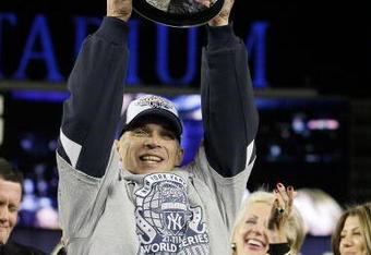 NEW YORK - NOVEMBER 4:  Manager Joe Girardi of the New York Yankees celebrates with the trophy after their 7-3 win against the Philadelphia Phillies in Game Six of the 2009 MLB World Series at Yankee Stadium on November 4, 2009 in the Bronx borough of New York City.  (Photo by David J. Phillip-Pool/Getty Images)