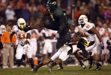 SAN DIEGO, CA - DECEMBER 30:   Runningback LeGarrette Blount #9 of the University of Oregon Ducks hurdles a player en route to a touchdown during his team's 42-31 win over the Oklahoma State University Cowboys in the Pacific Life Holiday Bowl at Qualcomm Stadium on December 30, 2008 in San Diego, California. (Photo by Donald Miralle/Getty Images)