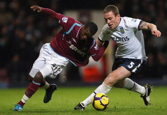 LONDON, ENGLAND - NOVEMBER 04:  Zavon Hines (L) of West Ham contests with Richard Dunne of Aston Villa during the Barclays Premier League match between West Ham United and Aston Villa at Upton Park on November 4, 2009 in London, England.  (Photo by Hamish Blair/Getty Images)