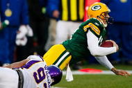 GREEN BAY, WI - NOVEMBER 01: Quarterback Aaron Rodgers #12 of the Green Bay Packers is sacked by Kevin Williams #93 of the Minnesota Vikings during the second quarter of the game at Lambeau Field on November 1, 2009 in Green Bay, Wisconsin. (Photo by Scott Boehm/Getty Images)