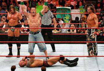 LAS VEGAS - AUGUST 24:  (L-R) Wrestlers Triple H, John Cena and Shawn Michaels celebrate as wrestler Randy Orton lies on the canvas during the WWE Monday Night Raw show at the Thomas & Mack Center August 24, 2009 in Las Vegas, Nevada.  (Photo by Ethan Miller/Getty Images)