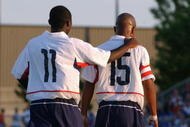 BLAINE, MN - JULY 13:  Forward Freddy Adu #11 of the U.S. Under-17 Men's National Team congradulates his teammate, forward Corey Ashe #15, during the friendly match against Canada Men's Junior Team at the National Sports Center on July 13, 2003 in Blaine, Minnesota.  The U.S. team won 3-1.  (Photo by Eric Miller/Getty Images) 