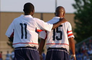 BLAINE, MN - JULY 13: Forward Freddy Adu #11 of the U.S. Under-17 Men's National Team congradulates his teammate, forward Corey Ashe #15, during the friendly match against Canada Men's Junior Team at the National Sports Center on July 13, 2003 in Blaine, Minnesota. The U.S. team won 3-1. (Photo by Eric Miller/Getty Images)