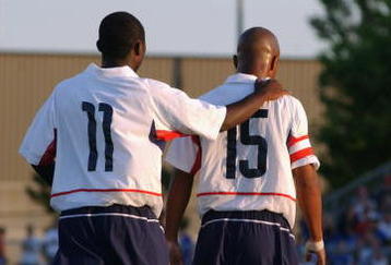 BLAINE, MN - JULY 13:  Forward Freddy Adu #11 of the U.S. Under-17 Men's National Team congradulates his teammate, forward Corey Ashe #15, during the friendly match against Canada Men's Junior Team at the National Sports Center on July 13, 2003 in Blaine, Minnesota.  The U.S. team won 3-1.  (Photo by Eric Miller/Getty Images) 
