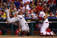 PHILADELPHIA - OCTOBER 31:  Nick Swisher #33 of the New York Yankees collides with Carlos Ruiz #51 of the Philadelphia Phillies as he scores in the top of the fifth inning in Game Three of the 2009 MLB World Series at Citizens Bank Park on October 31, 2009 in Philadelphia, Pennsylvania.  (Photo by Chris McGrath/Getty Images)