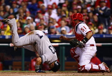 PHILADELPHIA - OCTOBER 31:  Nick Swisher #33 of the New York Yankees collides with Carlos Ruiz #51 of the Philadelphia Phillies as he scores in the top of the fifth inning in Game Three of the 2009 MLB World Series at Citizens Bank Park on October 31, 2009 in Philadelphia, Pennsylvania.  (Photo by Chris McGrath/Getty Images)